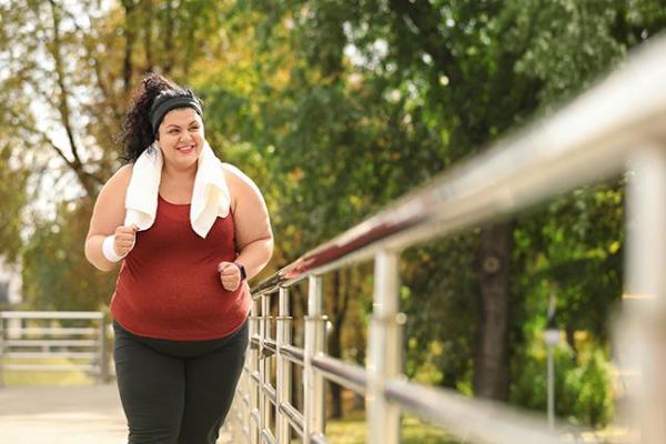 Ayuno intermitente - Mujer obesa haciendo ejercicio en el parque para combatir el sobrepeso 