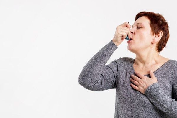 mujer mayor con un inhalador para tratar la enfermedad