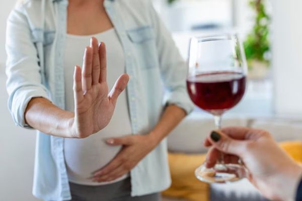 mujer rechazando una copa de vino