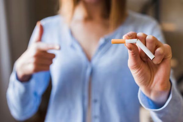 Joven rompe un cigarrillo a la mitad como símbolo de rechazo