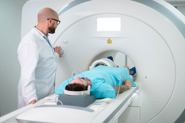 Densidad ósea - Radiólogo hace todos los ajustes para sacarle una resonancia magnética a paciente con fractura 