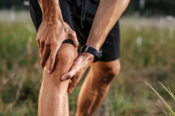 Trastornos musculoesqueléticos - Hombre agarrando su rodilla debido al fuerte dolor, el cual es causado por la artritis que padece